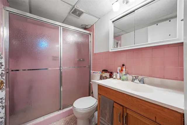 a bathroom with a sink toilet and shower