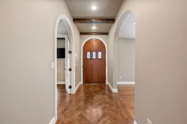 a room with wooden floor and windows
