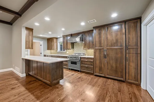 a kitchen with stainless steel appliances granite countertop a stove and a sink