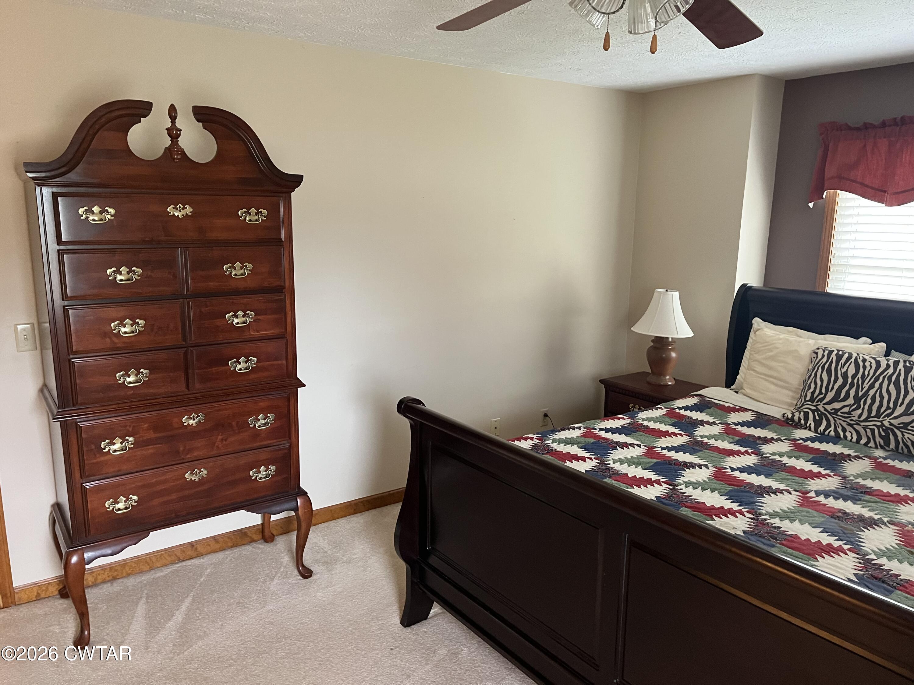 20 Homer Craig Road Humboldt, TN 38343 - Photo 17 of 28 a bedroom with a bed and a dresser in it