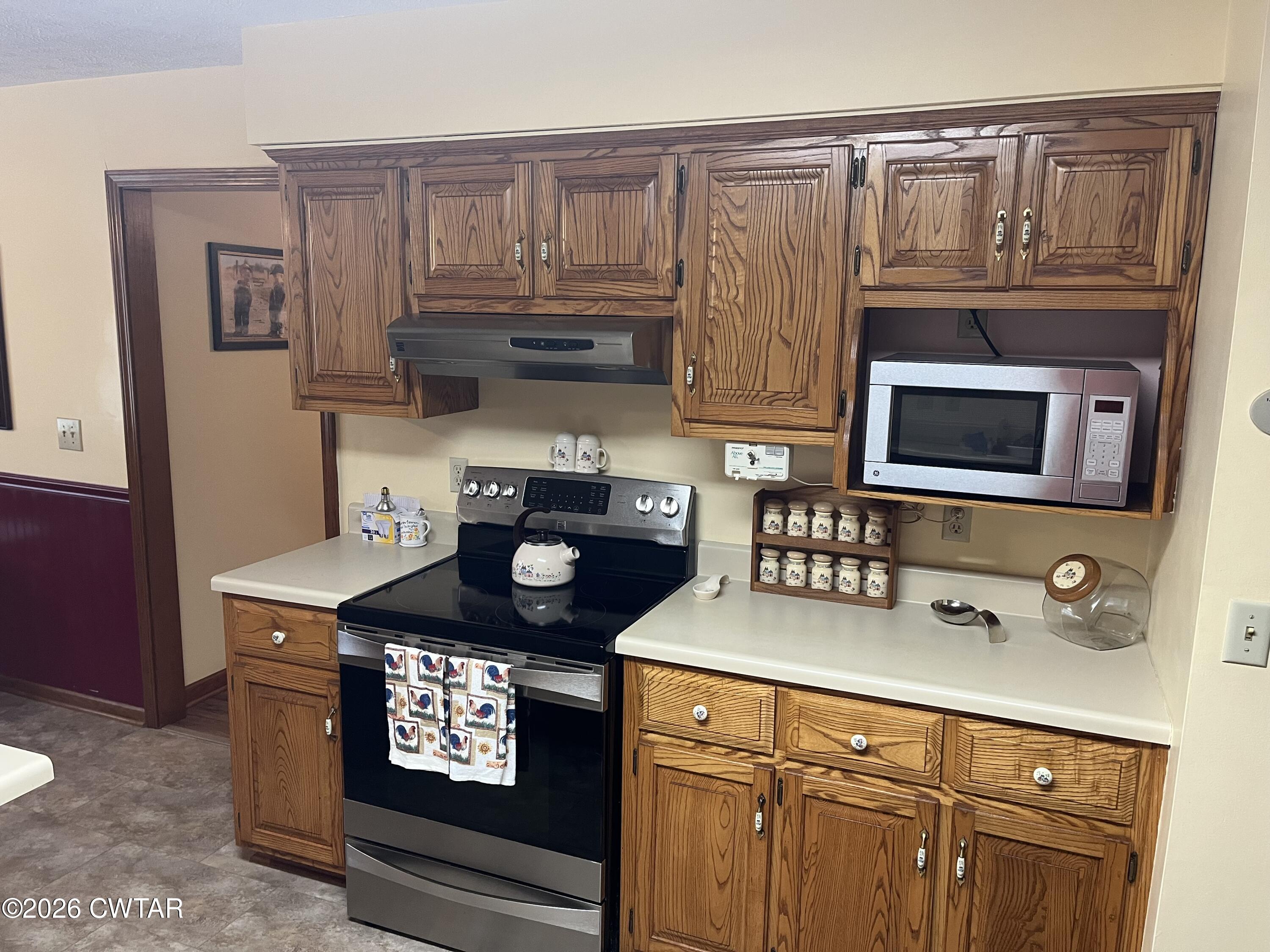 20 Homer Craig Road Humboldt, TN 38343 - Photo 8 of 28 a kitchen with stainless steel appliances granite countertop a stove and a microwave