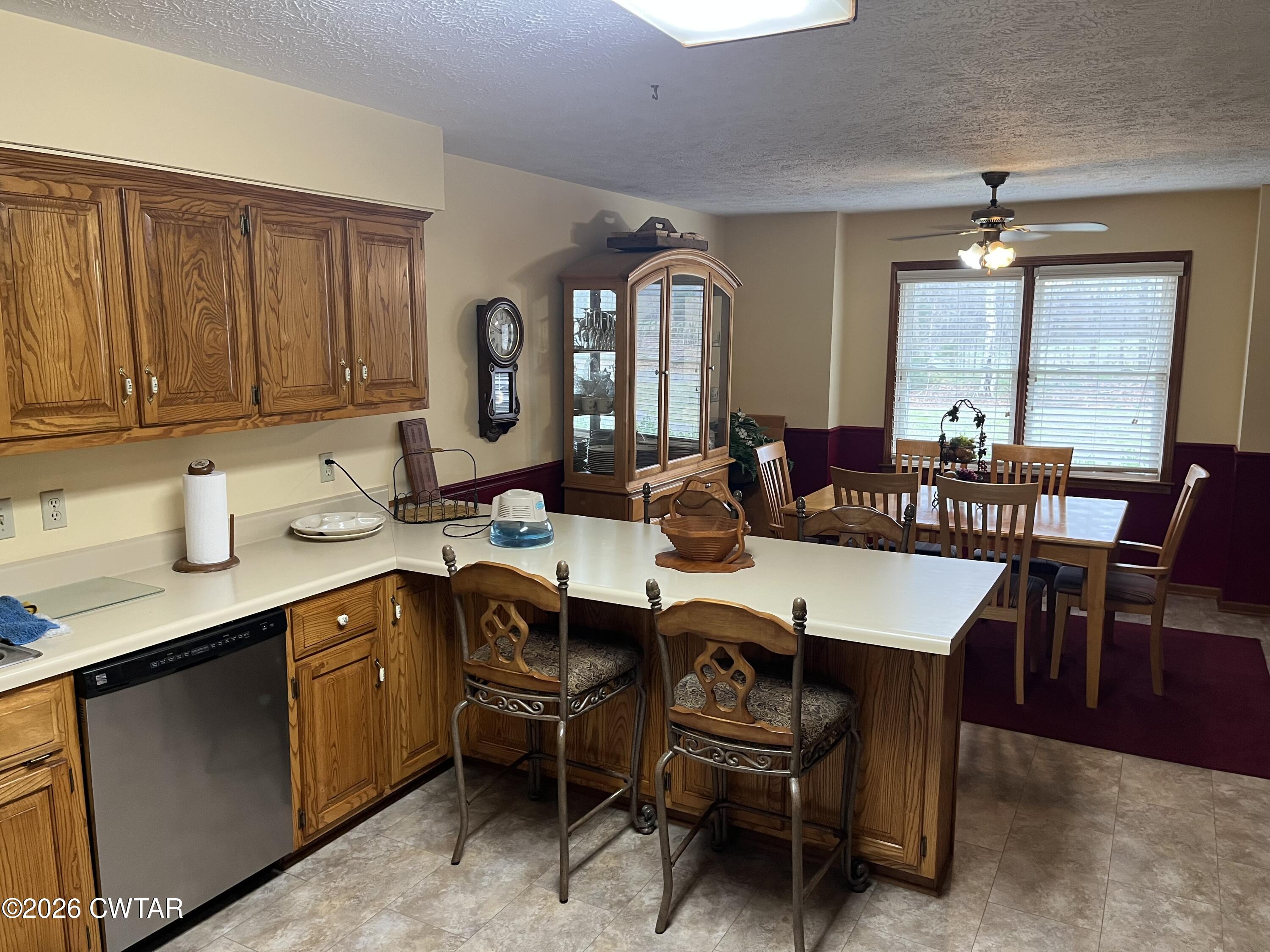 20 Homer Craig Road Humboldt, TN 38343 - Photo 9 of 28 a dining hall with stainless steel appliances granite countertop a dining table and chairs with wooden floor