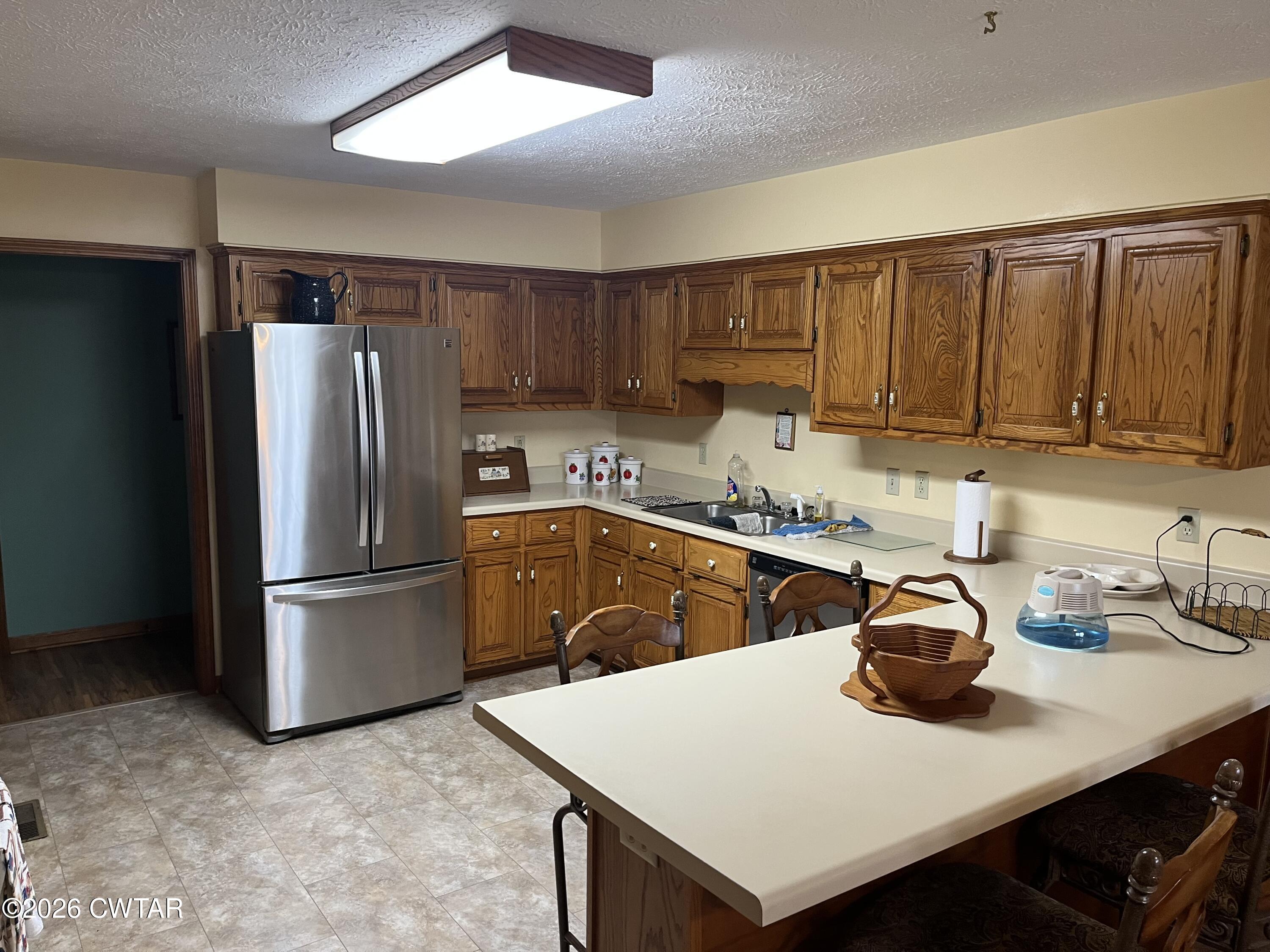 20 Homer Craig Road Humboldt, TN 38343 - Photo 10 of 28 a kitchen with a sink a refrigerator and a stove top oven