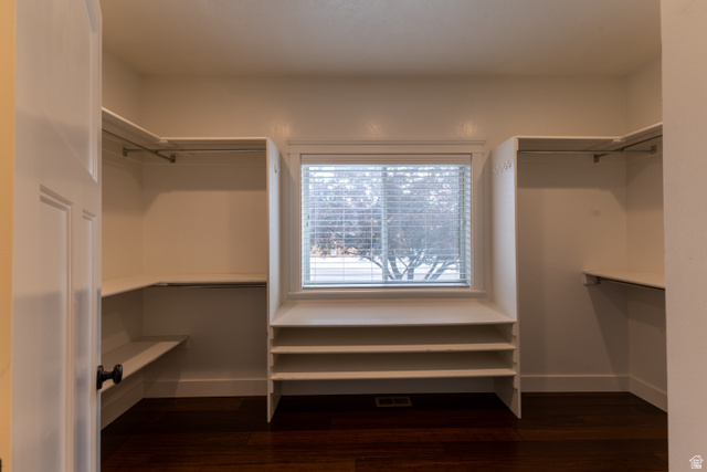 3565 West 1350th Street North Vernal, UT 84078 - Photo 22 of 54 Walk-in closet featuring built-in shelving, clothing rods, a window with blinds, and rich wood-finish flooring