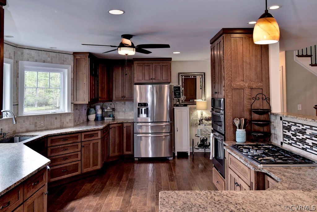 258 Sandy Bay Road Williamsburg, VA 23185 - Photo 11 of 50 a kitchen with stainless steel appliances granite countertop a refrigerator a sink dishwasher a stove and white countertops with wooden floor