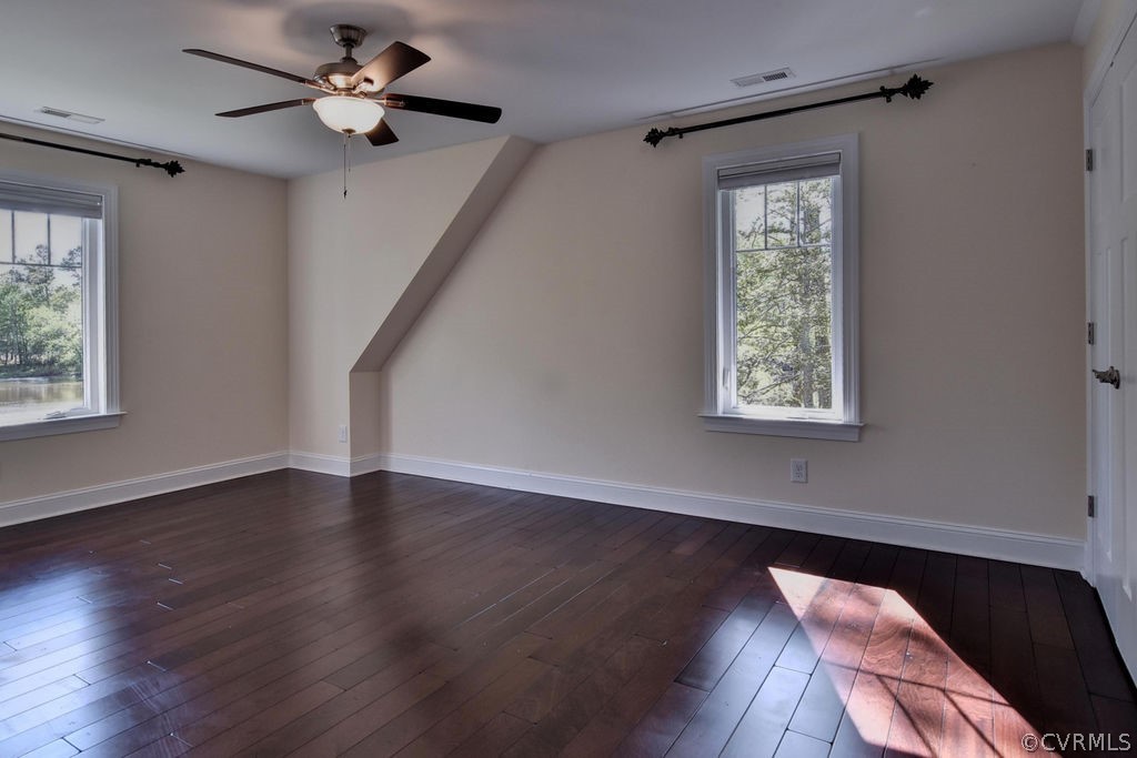 258 Sandy Bay Road Williamsburg, VA 23185 - Photo 28 of 50 a view of an empty room with wooden floor and a window