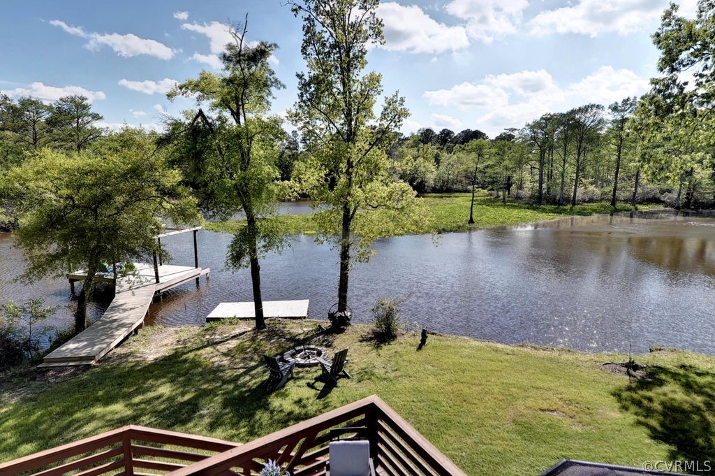258 Sandy Bay Road Williamsburg, VA 23185 - Photo 32 of 50 a view of a lake with a house in the background