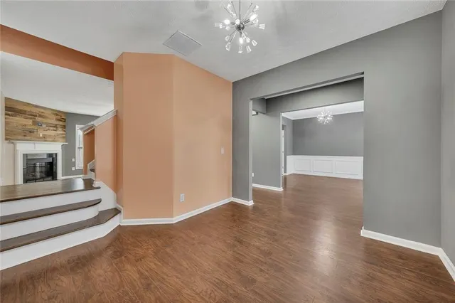 a view of a hallway with wooden floor and workspace