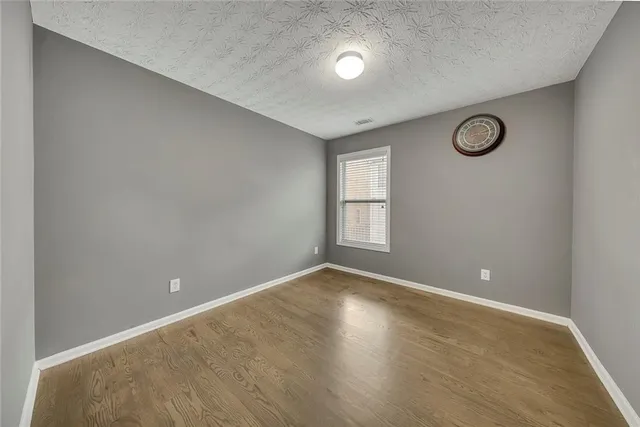 an empty room with windows and closet