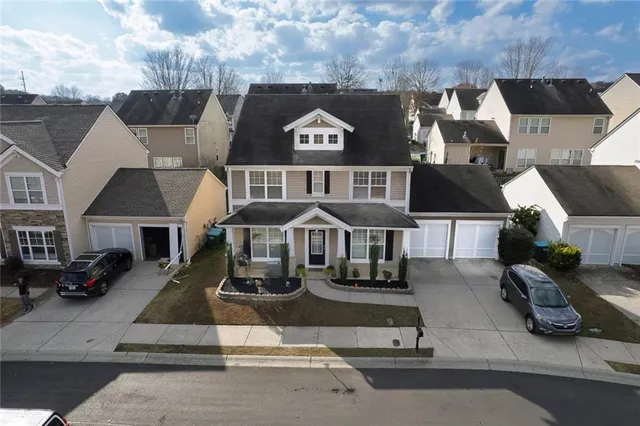 an aerial view of a house with a street