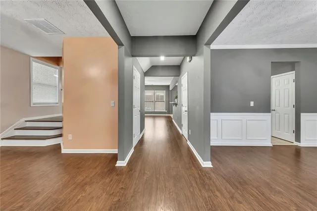 a view of a hallway with wooden floor
