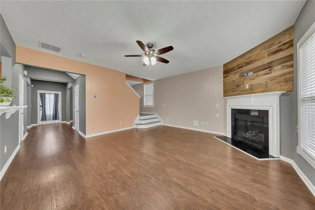 wooden floor in an empty room with a fireplace