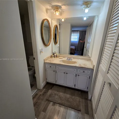 a bathroom with a double vanity sink and a mirror