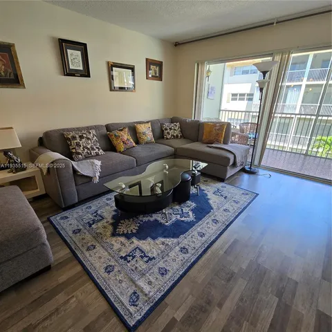 a living room with furniture rug and a table