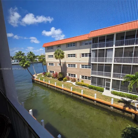 a view of swimming pool with outdoor seating and city view