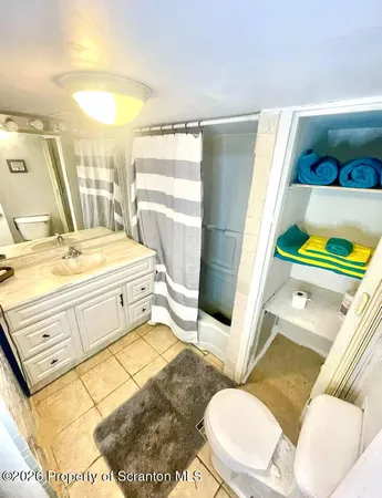 a bathroom with a sink mirror vanity and toilet