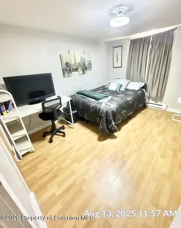a bedroom with a bed and a desk