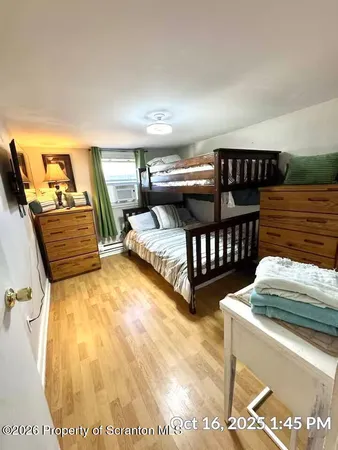 a bedroom with furniture and a wooden floor