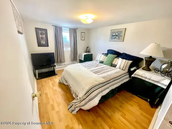 a bedroom with a bed and the view of bathroom