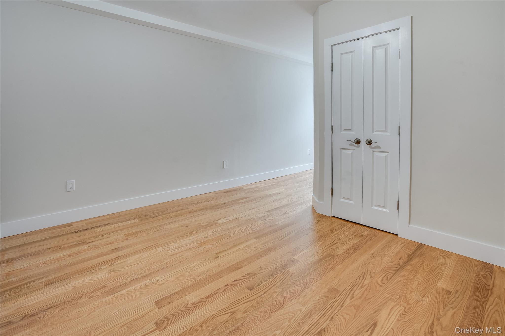 16 South Division Street, Unit 2A Peekskill, NY 10566 - Photo 6 of 8 a view of an empty room with wooden floor and a window