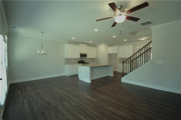 a view of kitchen with sink and wooden floor
