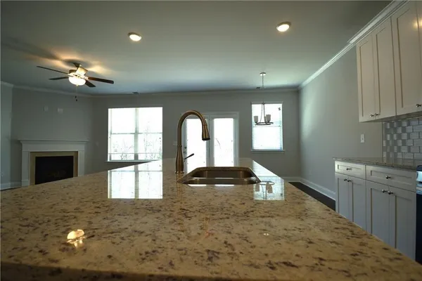 a view of an empty room with a fireplace and a window
