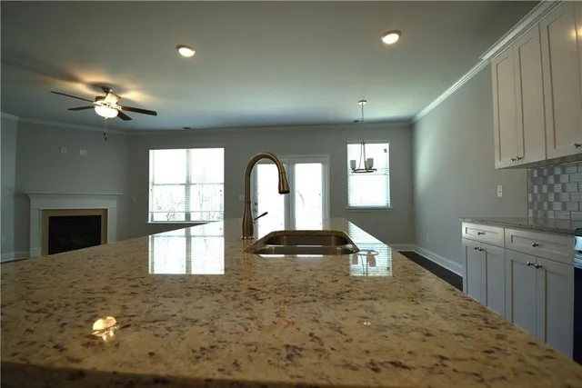 a view of an empty room with a fireplace and a window