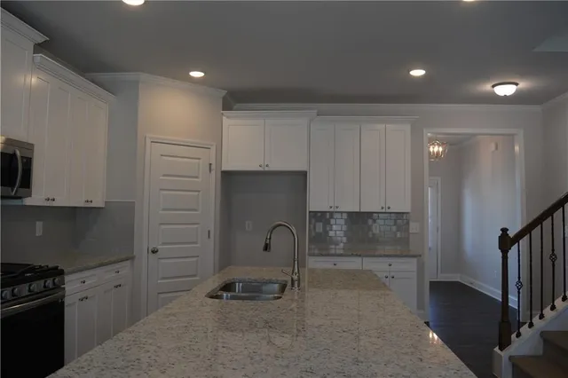 a kitchen with stainless steel appliances granite countertop a stove and a refrigerator