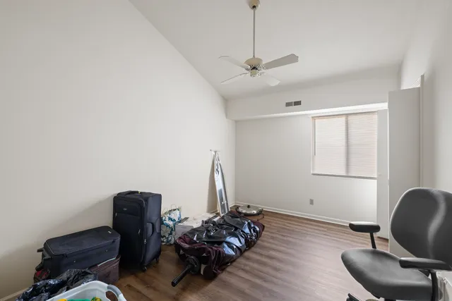 a bedroom with two beds and a chandelier