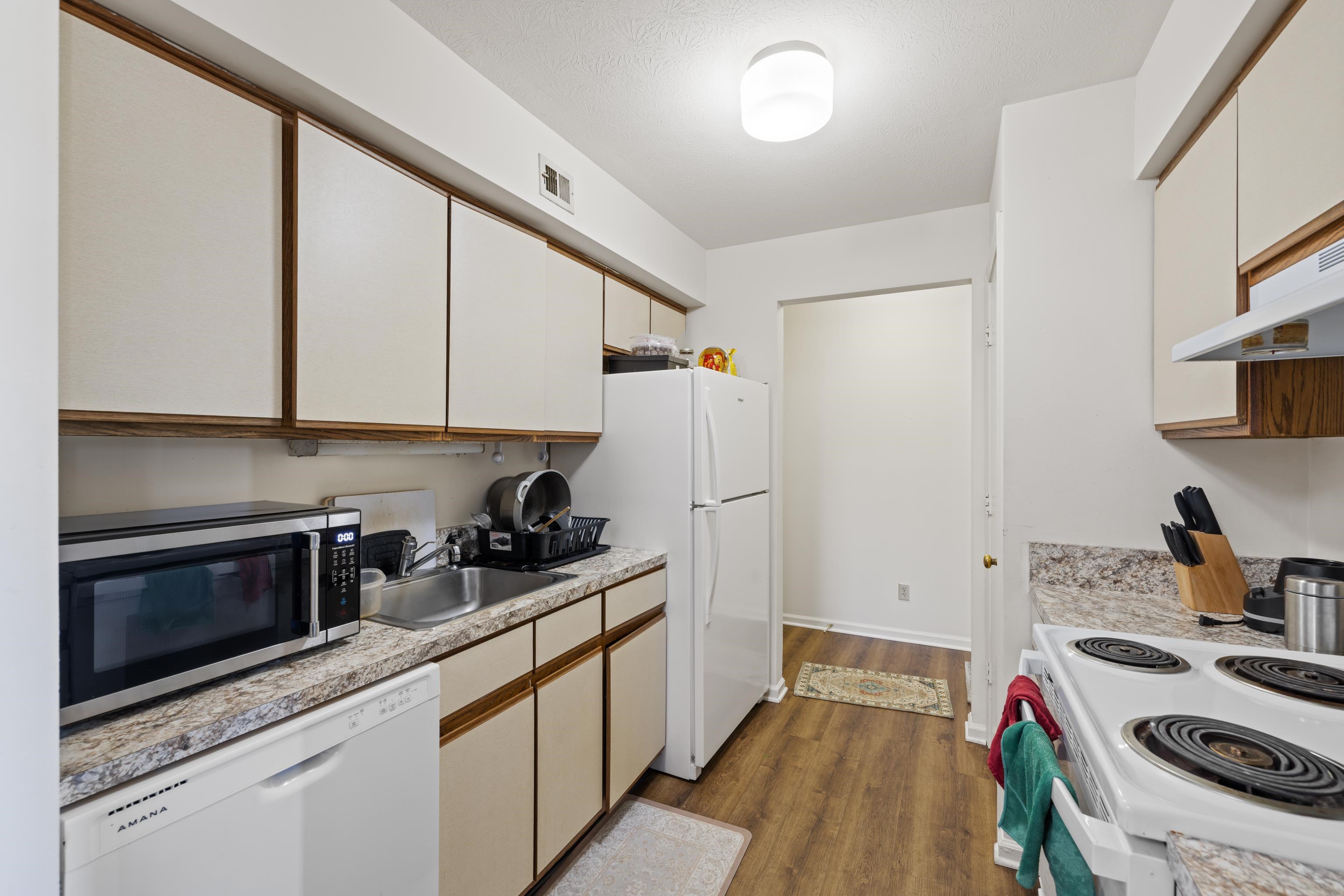 1116 Blue Ridge Drive, Unit 11 Harrisonburg, VA 22802 - Photo 9 of 21 a kitchen with sink a stove and cabinets
