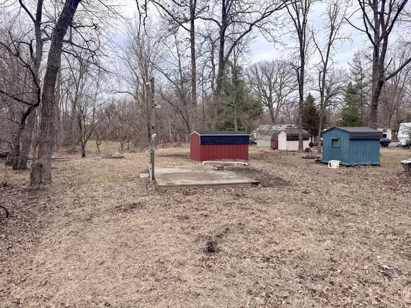 a view of a yard with wooden fence