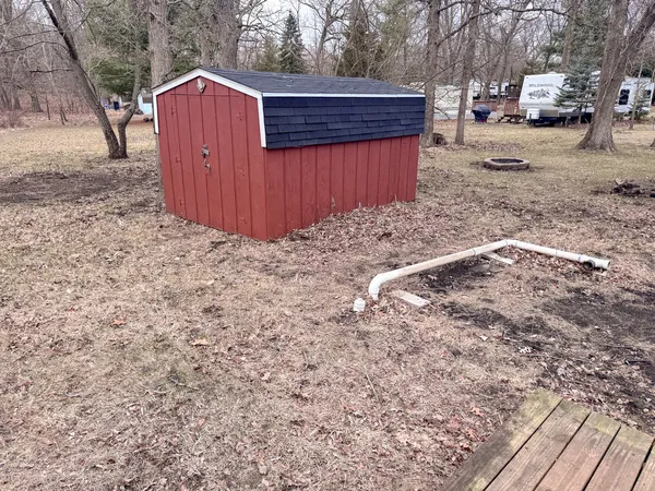 a view of backyard with wooden fence