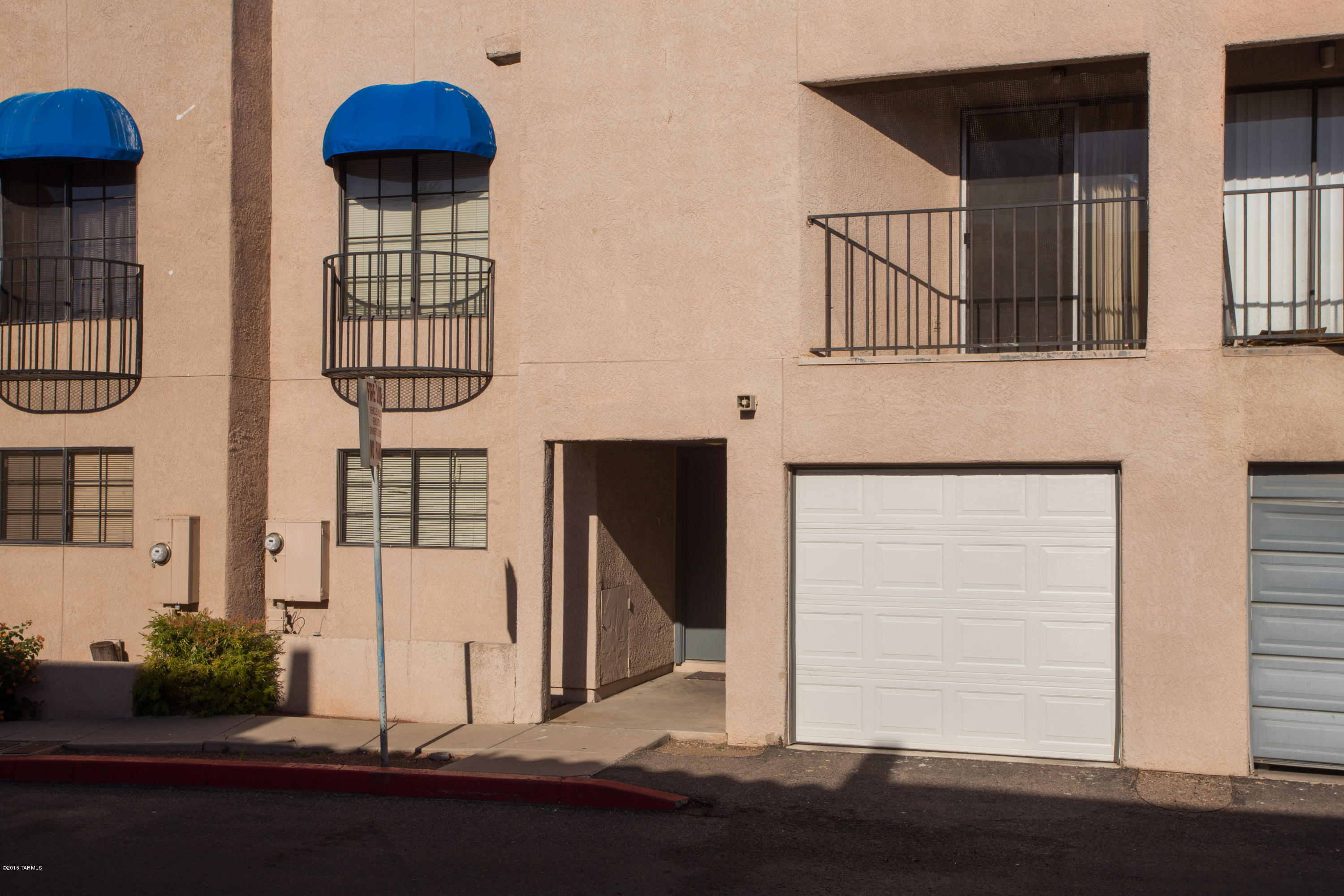 242 East Pastime Road Tucson, AZ 85705 - Photo 1 of 20 a front view of a house with entryway