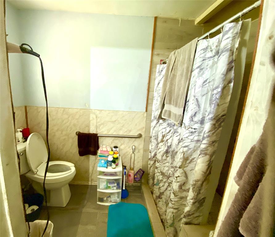 403 Mockingbird Street Chico, TX 76431 - Photo 11 of 25 a bathroom with a sink and a mirror