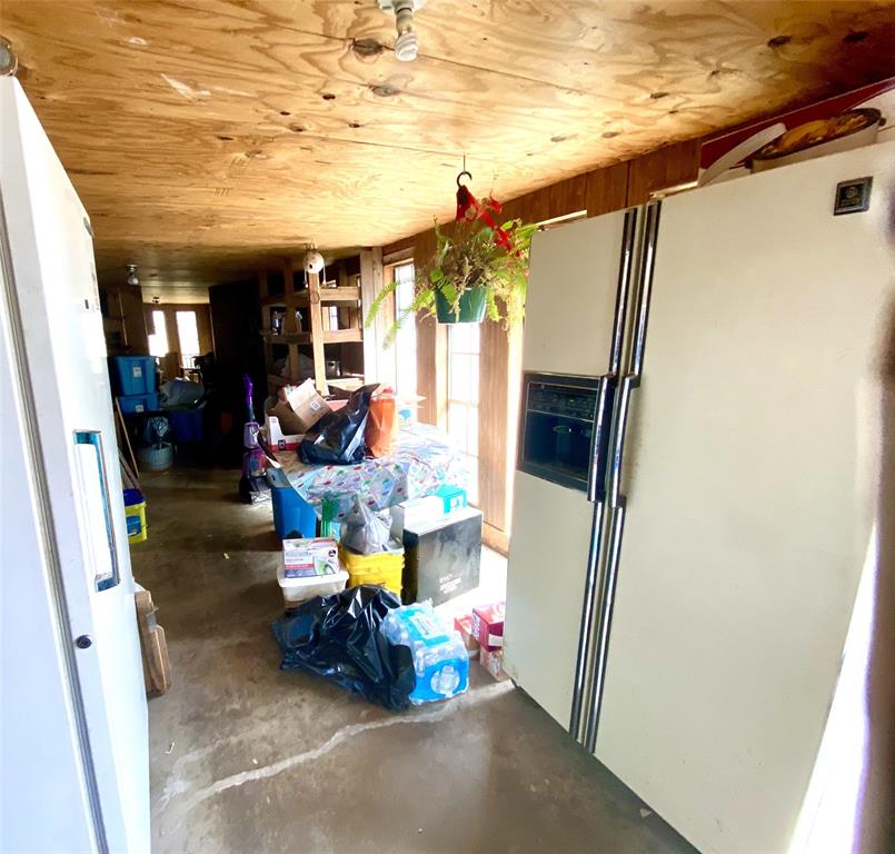 403 Mockingbird Street Chico, TX 76431 - Photo 14 of 25 a living room with furniture and a floor to ceiling window