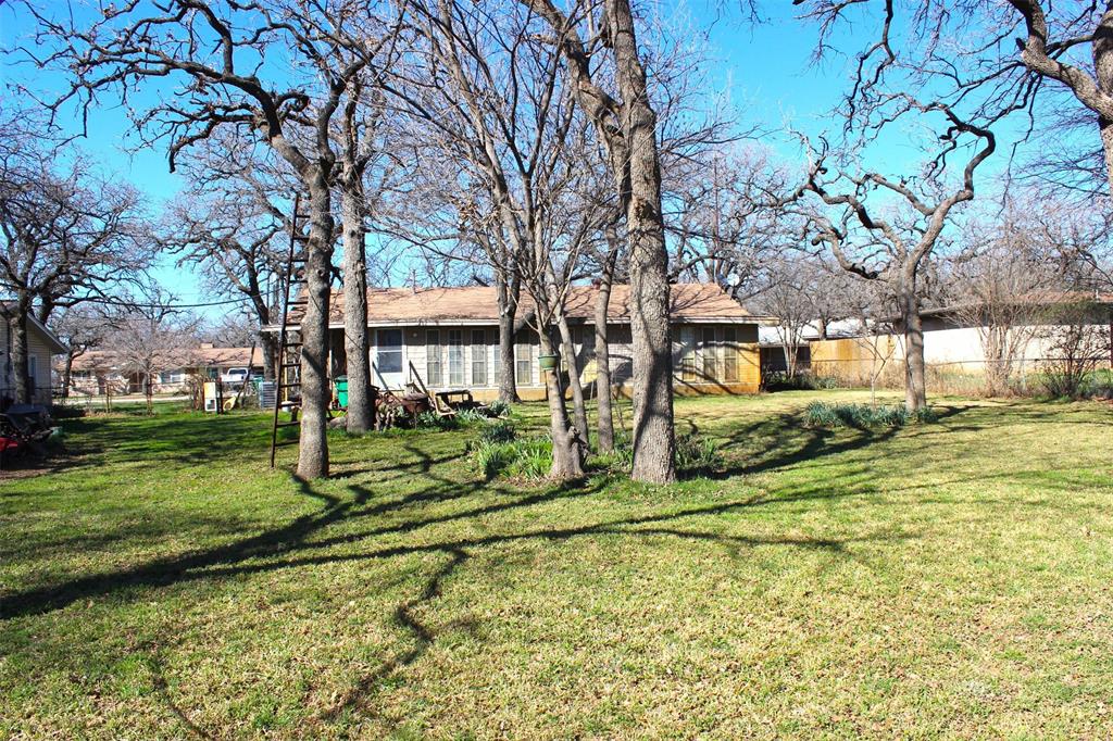 403 Mockingbird Street Chico, TX 76431 - Photo 17 of 25 a view of a house with a yard