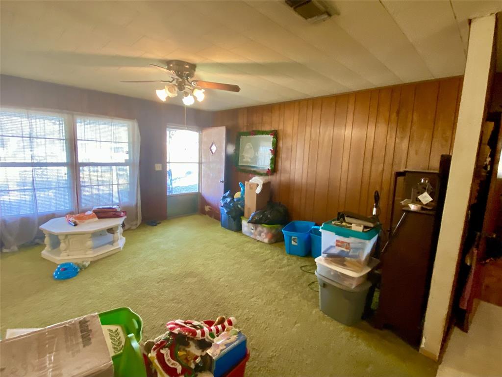 403 Mockingbird Street Chico, TX 76431 - Photo 5 of 25 a living room with furniture and a chandelier