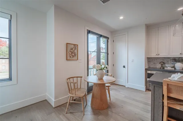 a living room with furniture and a kitchen