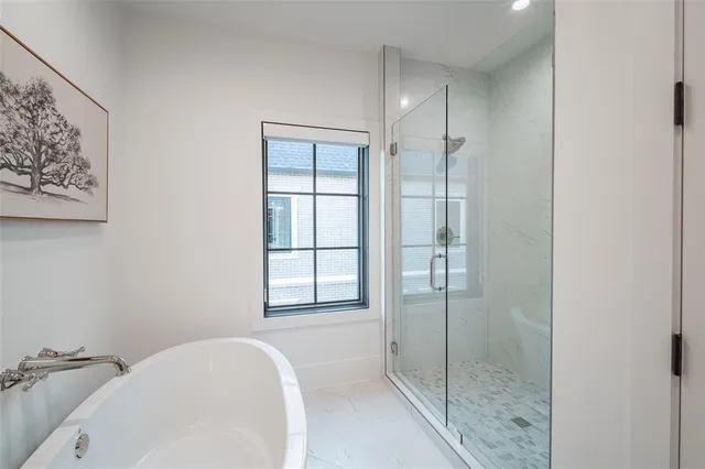a bathroom with a bathtub and shower