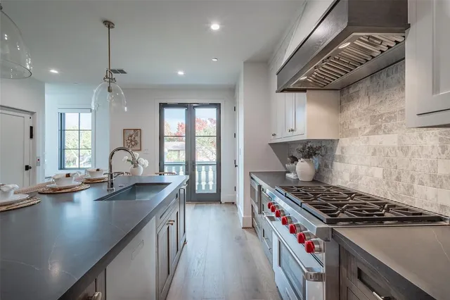 a kitchen with granite countertop a stove and a sink