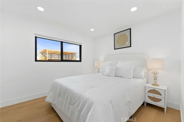 a bedroom with a bed and a painting on the wall