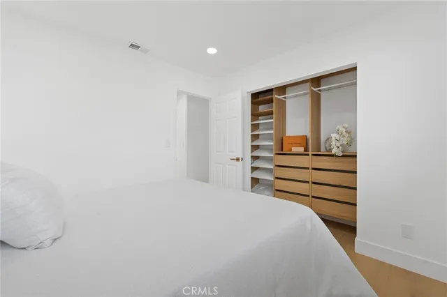 a bedroom with a bed and a cabinets