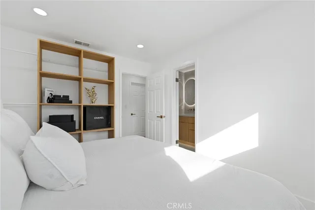 a room with a bed and glass window