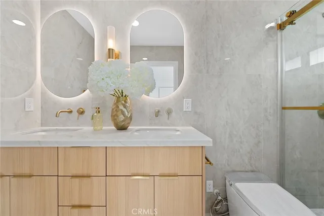 a bathroom with a sink a toilet and mirror