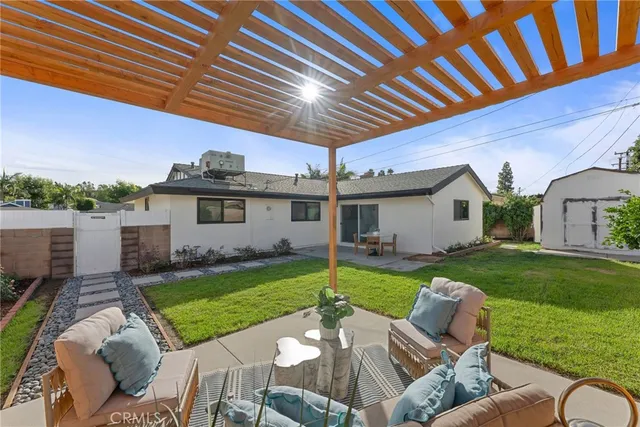 a view of a backyard with plants and a patio