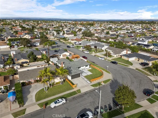 an aerial view of a residential houses with city view