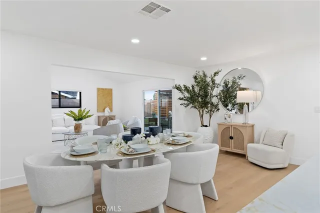 a view of a dining room with furniture and a potted plant