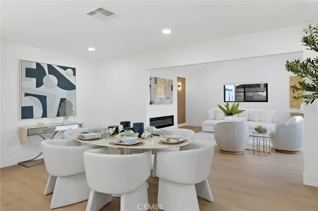 a dining room with furniture and wooden floor