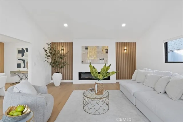 a living room with furniture and a potted plant