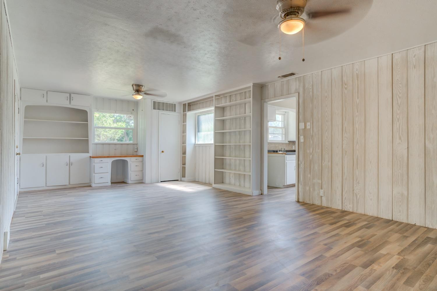 3411 41st Street Lubbock, TX 79413 - Photo 13 of 29 an empty room with wooden floor and windows